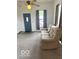 Living room with neutral carpet, a dark blue door, and a comfortable couch at 11 W Osage St, Greenfield, IN 46140