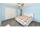 Bedroom featuring soft blue walls, ceiling fan, and plush gray carpet, and closet at 1101 Oakwood Trl, Indianapolis, IN 46260