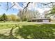 Spacious front yard and brick ranch style home with a large driveway at 1101 Oakwood Trl, Indianapolis, IN 46260