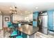 Open kitchen boasts granite countertops, stainless steel appliances, a breakfast bar, and ample cabinet space at 1101 Oakwood Trl, Indianapolis, IN 46260