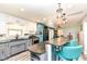 Modern kitchen features granite countertops, stainless steel appliances, and stylish blue and white cabinetry at 1101 Oakwood Trl, Indianapolis, IN 46260