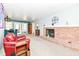 Living room with fireplace and large windows, furnished with a cozy red couch at 1101 Oakwood Trl, Indianapolis, IN 46260