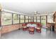 Bright sunroom with lots of windows, fan and table with seating at 1101 Oakwood Trl, Indianapolis, IN 46260