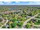Scenic aerial shot of a residential area featuring tree-lined streets, well-maintained homes, and a serene lake at 12669 Brookshire Pkwy, Carmel, IN 46033