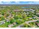 Expansive aerial view of a charming neighborhood with lush greenery and a tranquil lake in the distance at 12669 Brookshire Pkwy, Carmel, IN 46033