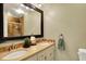 Bathroom with a large framed mirror, double sinks, and tile backsplash at 12669 Brookshire Pkwy, Carmel, IN 46033