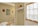 Charming half-bathroom with door to outside featuring decorative art adding character to the space at 12669 Brookshire Pkwy, Carmel, IN 46033