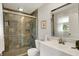 Bathroom boasts tiled shower, glass door, modern vanity, and decorative mirror at 12669 Brookshire Pkwy, Carmel, IN 46033