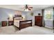 Serene bedroom with a comfortable sleigh bed, dresser, and ample natural light from the window at 12669 Brookshire Pkwy, Carmel, IN 46033