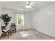 Carpeted bedroom with ceiling fan, neutral walls, and a window at 12669 Brookshire Pkwy, Carmel, IN 46033