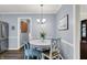 Cozy dining area featuring a round table, blue chairs, and soft lighting, creating a welcoming atmosphere for meals at 12669 Brookshire Pkwy, Carmel, IN 46033