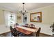 Formal dining room with wainscoting, elegant chandelier, and a large mirror at 12669 Brookshire Pkwy, Carmel, IN 46033