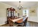 Charming dining room featuring a large table, china cabinet, and beautiful window at 12669 Brookshire Pkwy, Carmel, IN 46033