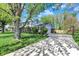 Spacious home featuring a long driveway and well-kept lawn with mature trees at 12669 Brookshire Pkwy, Carmel, IN 46033