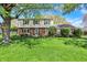 Charming two-story brick home with manicured lawn and mature shade tree at 12669 Brookshire Pkwy, Carmel, IN 46033