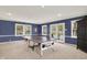 A bright recreational space featuring a ping pong table and doors leading to the outdoor pool area at 12669 Brookshire Pkwy, Carmel, IN 46033