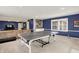 Recreational room with blue walls, built-in shelves, and a ping pong table for entertainment at 12669 Brookshire Pkwy, Carmel, IN 46033