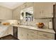 Charming kitchen with stainless dishwasher, light countertops, and natural lighting at 12669 Brookshire Pkwy, Carmel, IN 46033