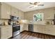 Cozy kitchen with wood-look floors, stainless appliances, and bright natural light at 12669 Brookshire Pkwy, Carmel, IN 46033