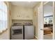 Functional laundry area with modern washer and dryer, complemented by ample cabinet storage space at 12669 Brookshire Pkwy, Carmel, IN 46033