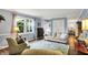 Cozy living room with a view to the backyard, neutral colors, and hardwood floors at 12669 Brookshire Pkwy, Carmel, IN 46033