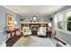 Bright living room with a brick fireplace, built-ins, and large window at 12669 Brookshire Pkwy, Carmel, IN 46033