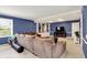 Inviting living room with a comfortable sectional sofa, built-in shelving, and a mounted television at 12669 Brookshire Pkwy, Carmel, IN 46033