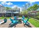 Backyard patio area with a fire pit, chairs, and dining set offers space for outdoor living at 12669 Brookshire Pkwy, Carmel, IN 46033