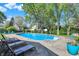 Backyard pool area features lounge chairs, landscaping, hardscape and a basketball hoop at 12669 Brookshire Pkwy, Carmel, IN 46033