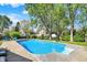 Backyard pool with concrete surround and diving board under a bright blue sky at 12669 Brookshire Pkwy, Carmel, IN 46033