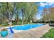 Backyard pool with concrete surround, diving board and planter at 12669 Brookshire Pkwy, Carmel, IN 46033
