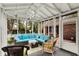Enclosed sunroom with comfortable seating and an exterior view of the backyard and pool at 12669 Brookshire Pkwy, Carmel, IN 46033