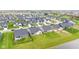 A view of homes backing onto a pond, showing backyard patios and well-maintained lawns at 1295 Clairet Dr, Westfield, IN 46074