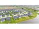An aerial view reveals a neighborhood with a central pond, winding roads, and lush landscaping at 1295 Clairet Dr, Westfield, IN 46074