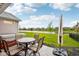 A picturesque backyard features a patio set, green lawn, and serene lake views at 1295 Clairet Dr, Westfield, IN 46074