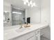 Bright bathroom featuring a white sink, countertop, and a glass-enclosed shower with marble tiling at 1295 Clairet Dr, Westfield, IN 46074