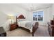 Comfortable bedroom with plush carpet, a carved wood bed frame, and a large window at 1295 Clairet Dr, Westfield, IN 46074