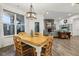 Inviting dining space featuring hardwood floors, bright lighting, an outdoor view, and a view of the living room at 1295 Clairet Dr, Westfield, IN 46074