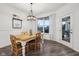 Dining area featuring hardwood floors, vintage chandelier, bright lighting, and a view of the backyard at 1295 Clairet Dr, Westfield, IN 46074