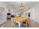 Open-concept dining area with hardwood floors, vintage chandelier, table, and views of the living area at 1295 Clairet Dr, Westfield, IN 46074