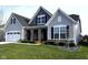 Charming home with stone accents, a well-manicured lawn, and an attached two-car garage at 1295 Clairet Dr, Westfield, IN 46074