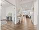 Bright, hardwood-floored foyer showcasing a tasteful console table and glimpses of the expansive living spaces at 1295 Clairet Dr, Westfield, IN 46074