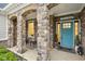 Charming front entrance with stone columns and a bright blue front door at 1295 Clairet Dr, Westfield, IN 46074