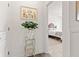 Hallway featuring wood floors, white trim, and a glimpse into the cozy bedroom at 1295 Clairet Dr, Westfield, IN 46074