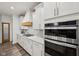 Modern kitchen featuring stainless steel oven, gas cooktop, stone countertops, and white cabinetry at 1295 Clairet Dr, Westfield, IN 46074