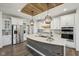 Modern kitchen featuring an island with a stone counter, stainless steel appliances, and pendant lighting at 1295 Clairet Dr, Westfield, IN 46074