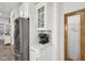 Kitchen area features stainless steel refrigerator, coffee station, and a convenient pantry with decorative glass door at 1295 Clairet Dr, Westfield, IN 46074