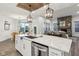 Bright kitchen boasts a large island, stainless steel appliances, modern lighting, and easy access to dining and living at 1295 Clairet Dr, Westfield, IN 46074