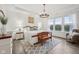 Bright main bedroom features a tray ceiling, a stylish chandelier, large windows, and decorative wall trim at 1295 Clairet Dr, Westfield, IN 46074