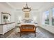 Bright main bedroom features a tray ceiling, a stylish chandelier, large windows, and decorative wall trim at 1295 Clairet Dr, Westfield, IN 46074